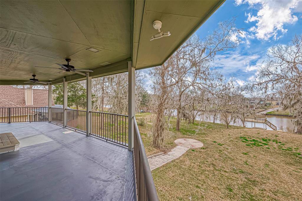 Stretching across the back of the home, this spacious balcony offers plenty of room for outdoor seating, dining, or simply taking in the view. Two ceiling fans keep the space comfortable, making it perfect for year-round enjoyment.