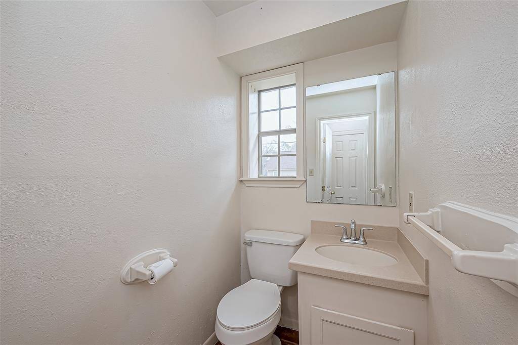 Simple and inviting, this bathroom serves as a convenient main-level addition. The well-placed fixtures and efficient layout maximize space without sacrificing comfort.