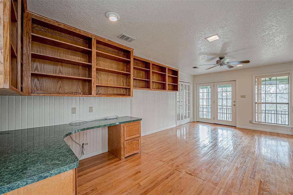 A large window allows natural light to flood the loft, creating a bright and comfortable setting. With built-in overhead wood shelving for extra storage and direct access to the spacious balcony, this space is both functional and full of potential.