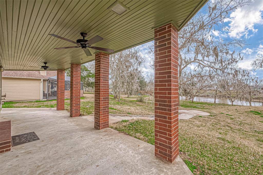 Directly below the balcony, this covered patio mirrors its size, offering a generous outdoor area protected from the elements. Supported by sturdy brick pillars, the space is ideal for entertaining, dining, or lounging.