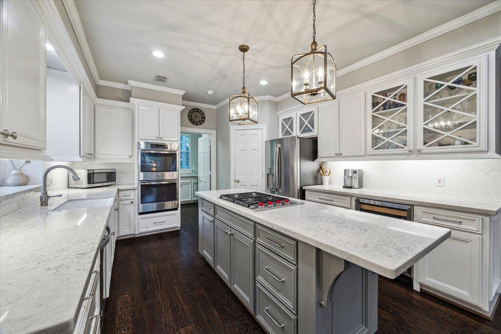 Note the beautiful glass cabinetry and farm sink!