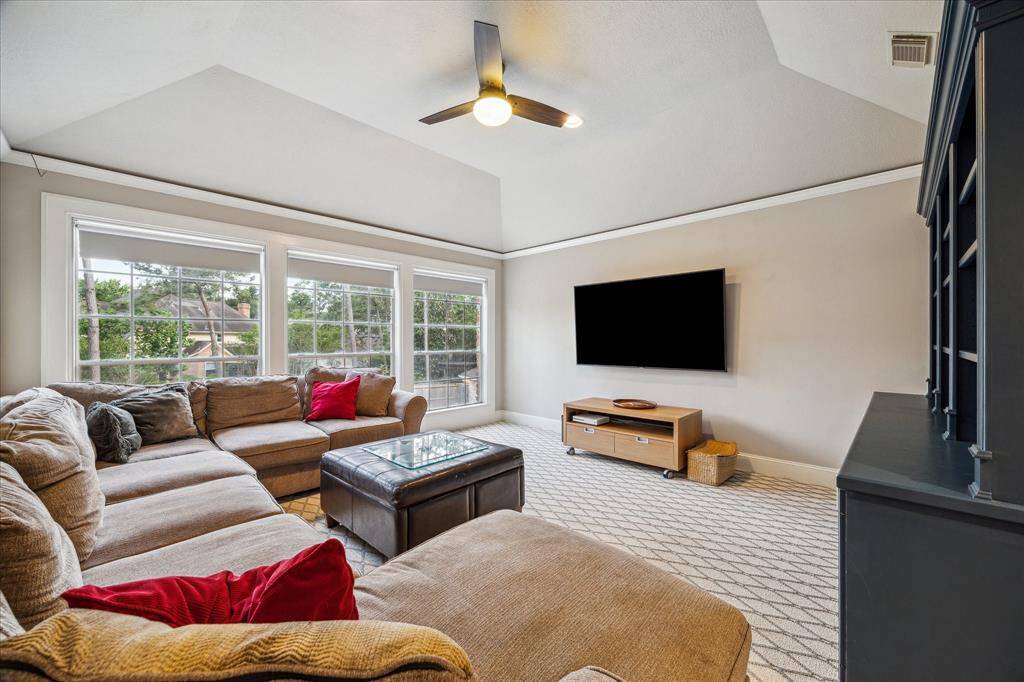 Spacious game room with built-ins is perfect for movie night! Note the windows letting in ample amount of natural light!