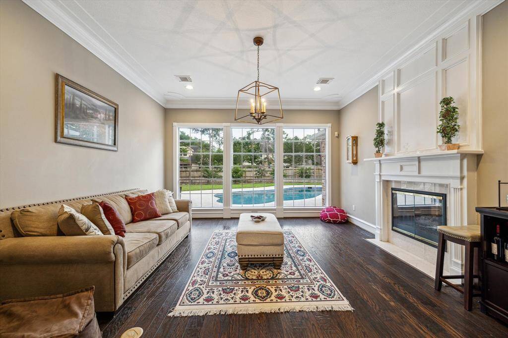 Wonderful living space featuring dual sided fireplace and views of the sparkling pool!