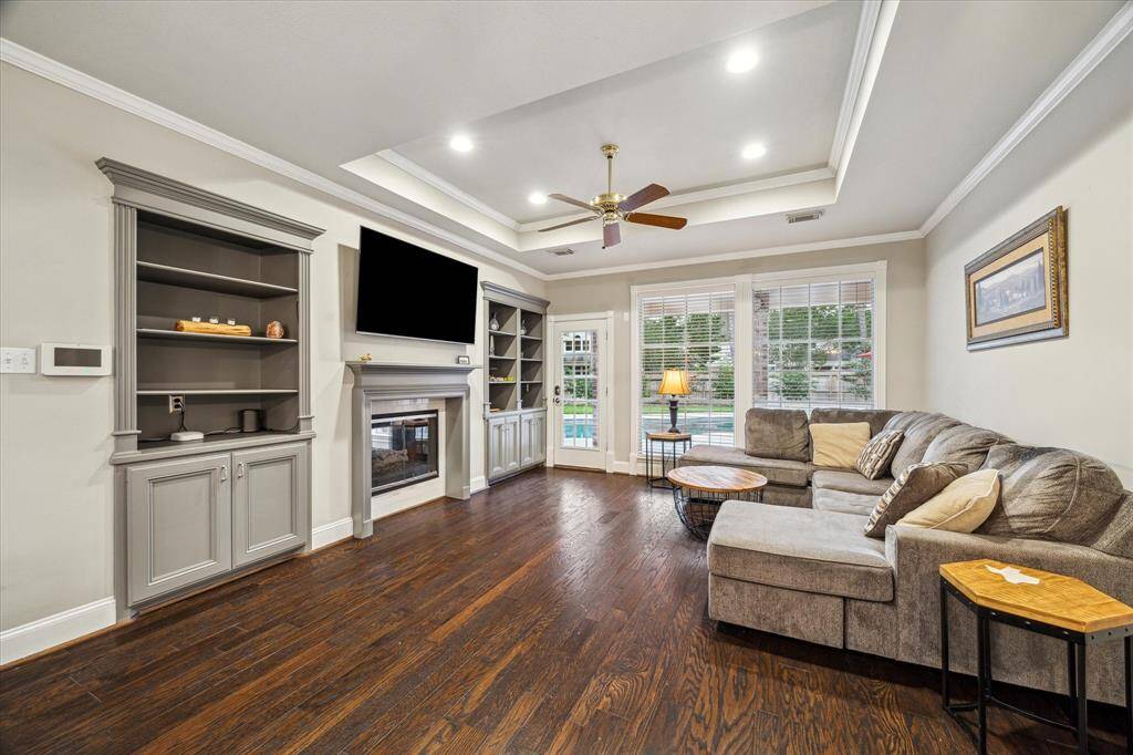 Family room with built-ins, dual sided fireplace and access to backyard.