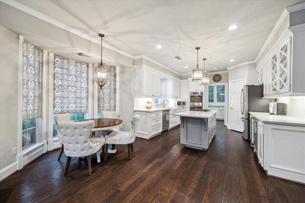 Light and bright concept kitchen that flows into breakfast area and family room.