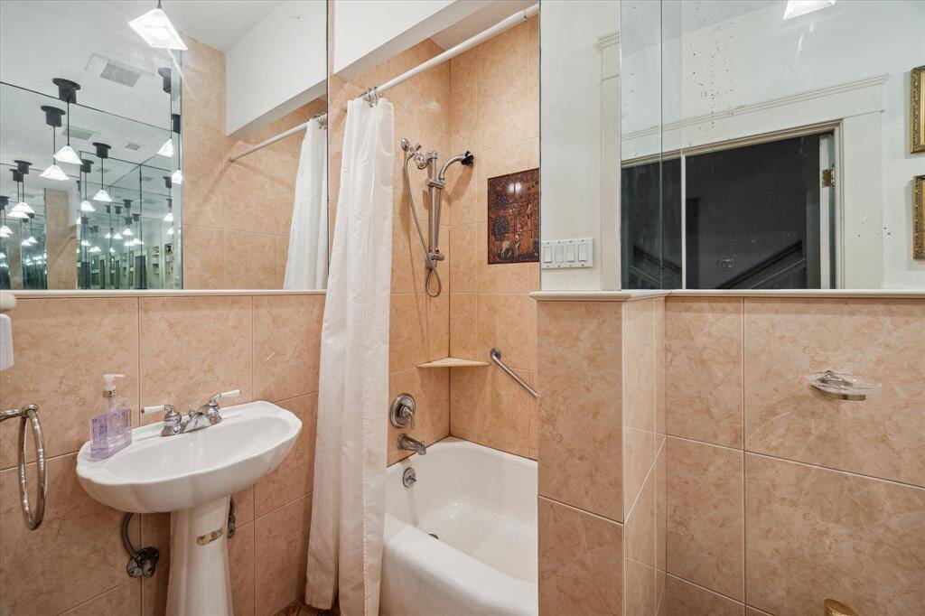 The first floor bathroom is a full bath w/ small tub & shower combo, pedestal sink, bidet & toilet...plenty of room to create a beautiful new bathroom if you so choose!
