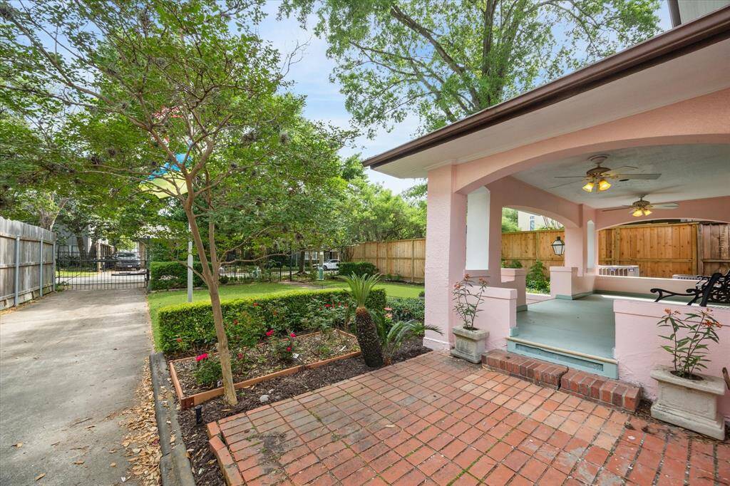 A view of the front porch and back toward the front yard, gated entry and lovely street.