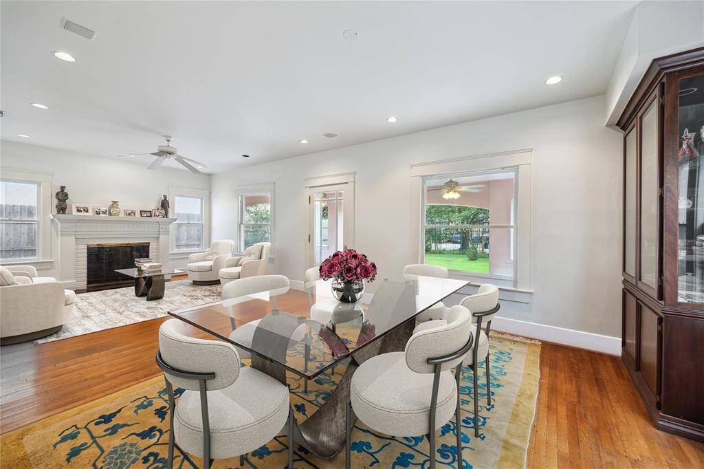 As you enter the home, you're greeted with an open formal living and dining room, along with beautiful wood floors. This photo has been virtually staged.