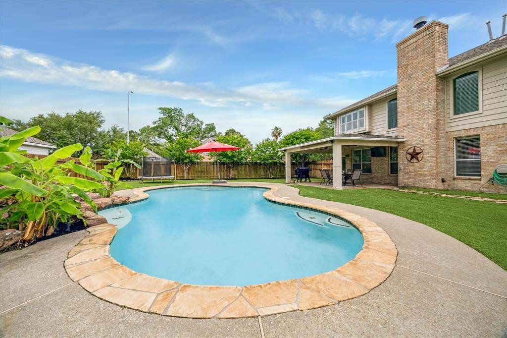 Stunning pool with rock wall waterfall.