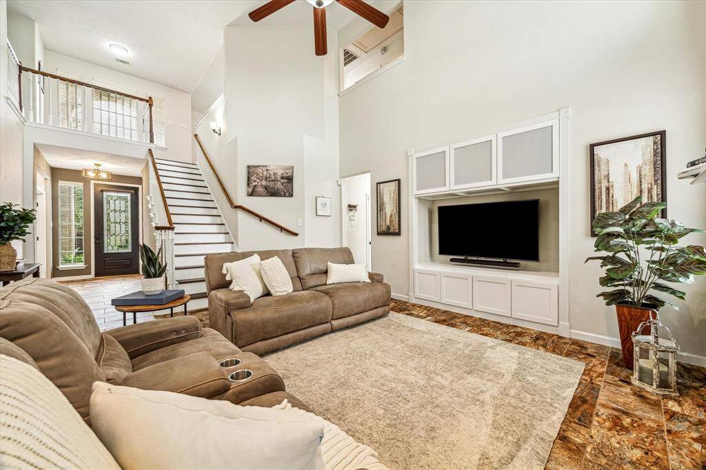 Soaring ceilings with a large living area open to kitchen and views of backyard oasis!