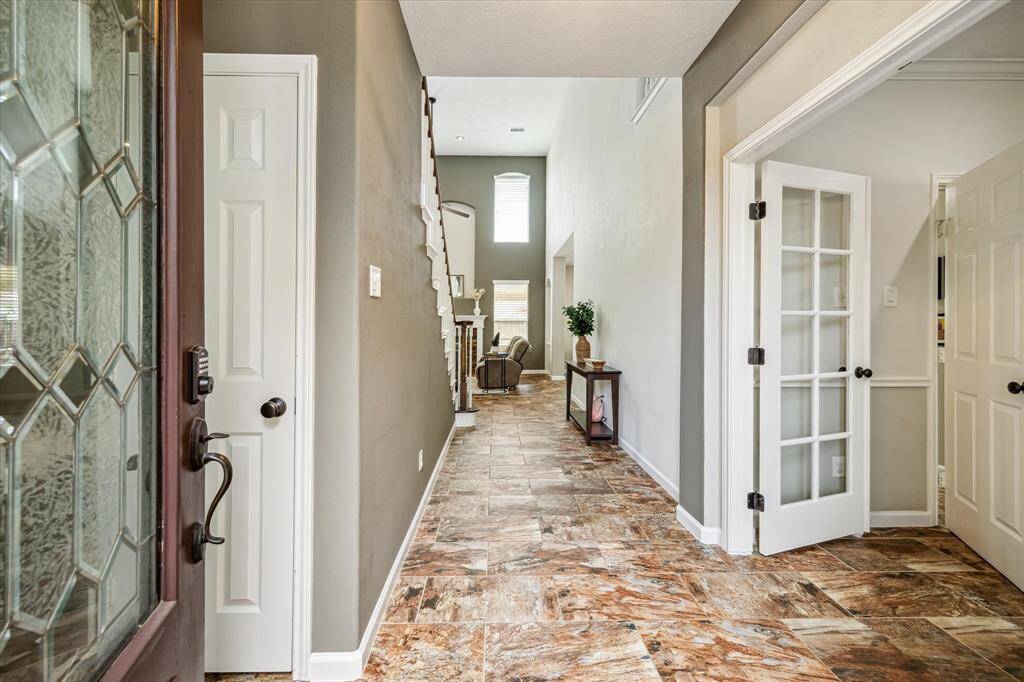 Entry leading to the soaring ceiling .living room