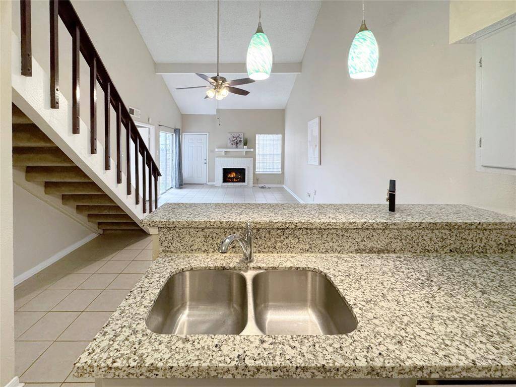 The kitchen features a breakfast bar perfect for morning coffee