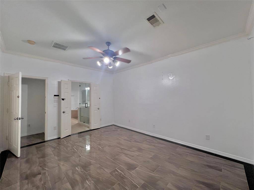 Primary bedroom with tiled flooring