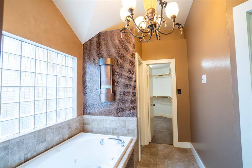 View of tub and walk-in closet