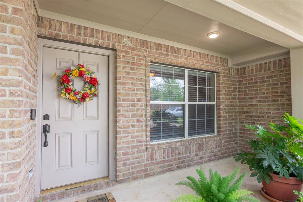 Charming front entrance featuring a cozy porch area with a large window for natural light.
