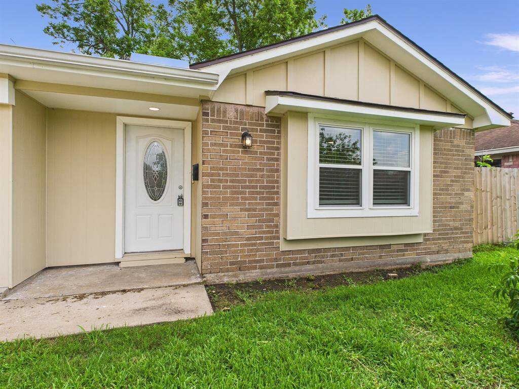 Charming single-story home with a brick exterior and inviting front entrance.