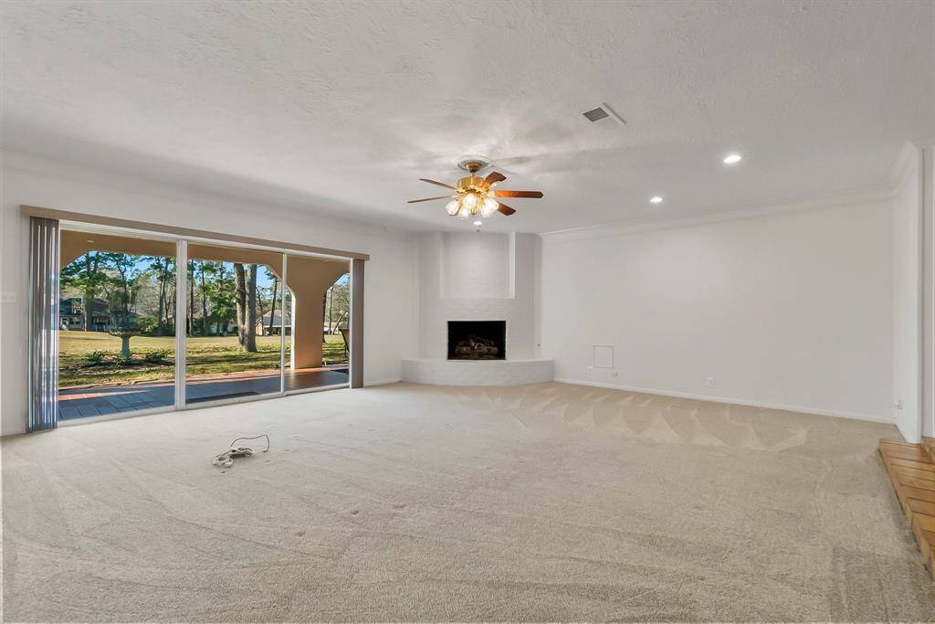Family room with beautiful gas log fireplace. Updated ceiling fans and globes. New Bluetooth smoke alarms added.
