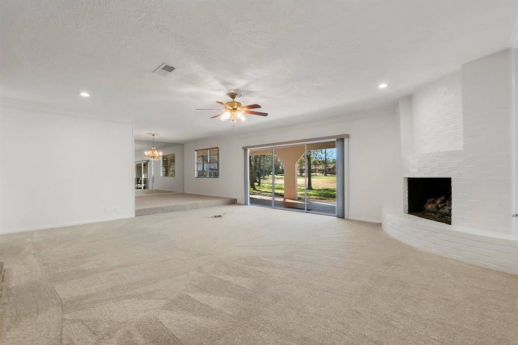 Large family room, lots of natural light, windows adorned with elegant treatments. Seamlessly connecting to the dining room-perfect for gatherings!