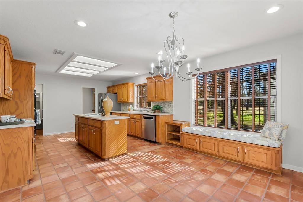 Large kitchen, open concept layout, abundant cabinetry and storage, island with cooktop. SS appliances.  New dishwasher. New disposal. Huge walk-in pantry.