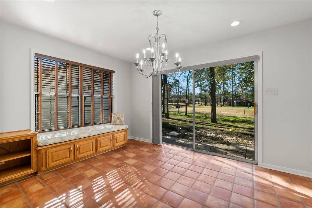 Beautiful window seating area with added storage.  Large breakfast area. Sliding glass door with custom treatments.