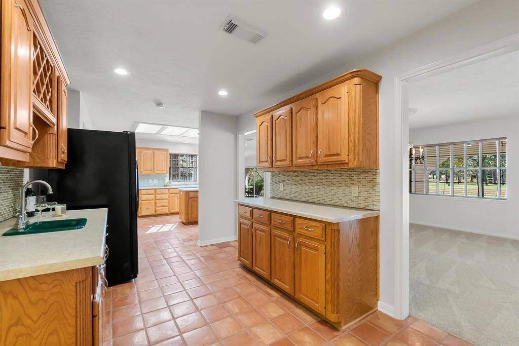 Countertops and backsplash updated in the butler's pantry/wet bar area. All new hardware/pulls replaced. More storage! Easy access to the kitchen and formal dining area.