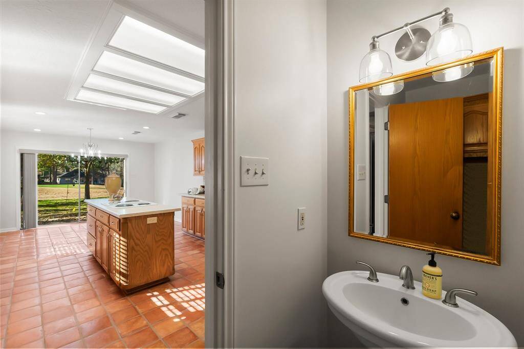 Half bath with new hardware, new lighting.