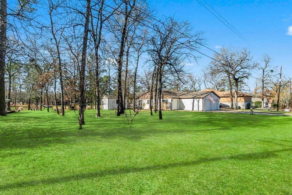 Surrounded by lush, mature trees. Serene private setting. Sprinkler system on the lot that the home sits on. Photos edited to reflect greener grass.