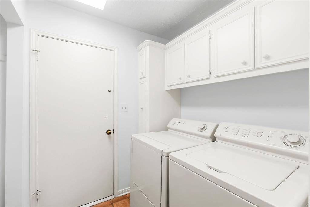 Washer and Dryer included. Interior utility room with storage and area for hanging clothing.