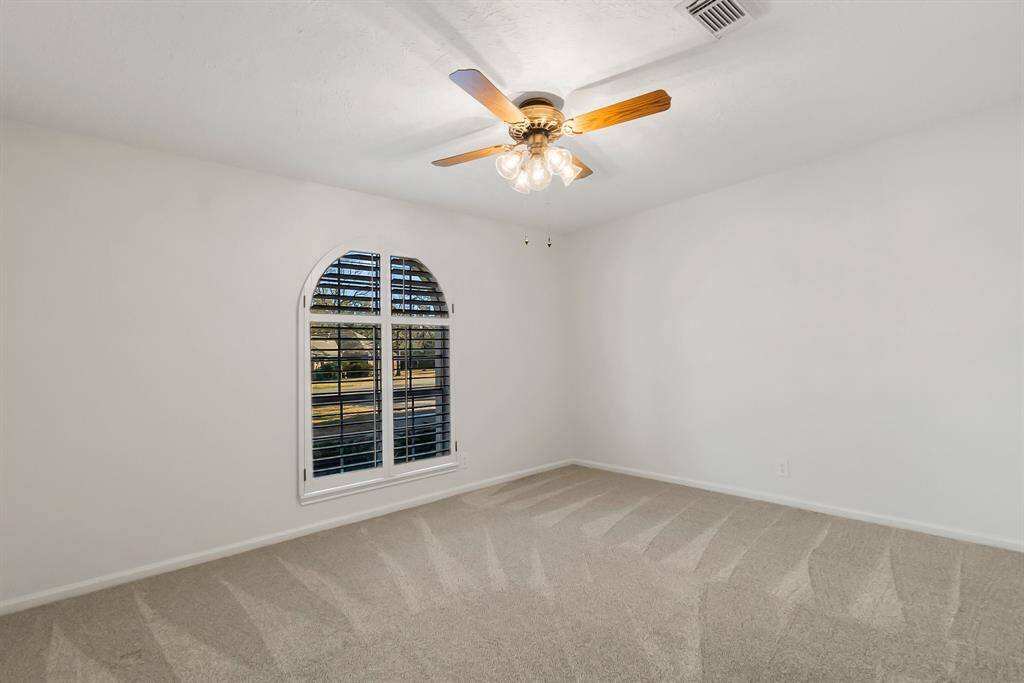 Secondary bedroom with plantation shutters.