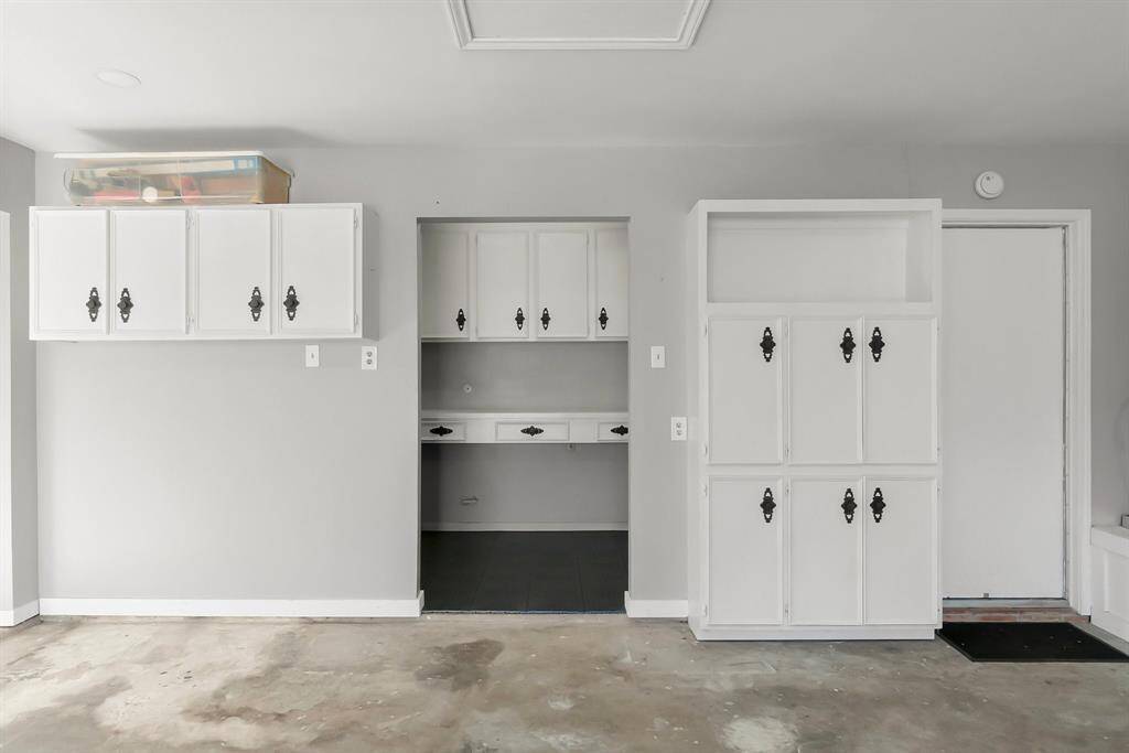 Designated work area with newly added flooring and built-ins for added storage in the 2 car oversized garage. Garage door openers.