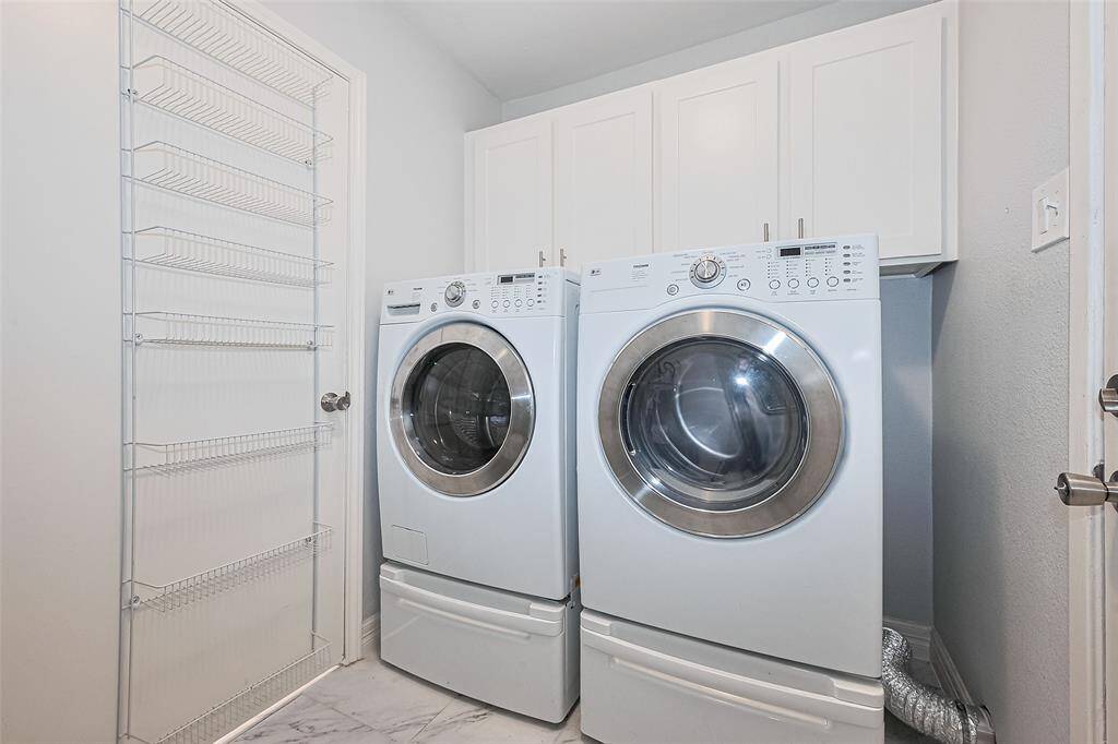 Utility room with LG washer and dryer. Door leads to the back patio.