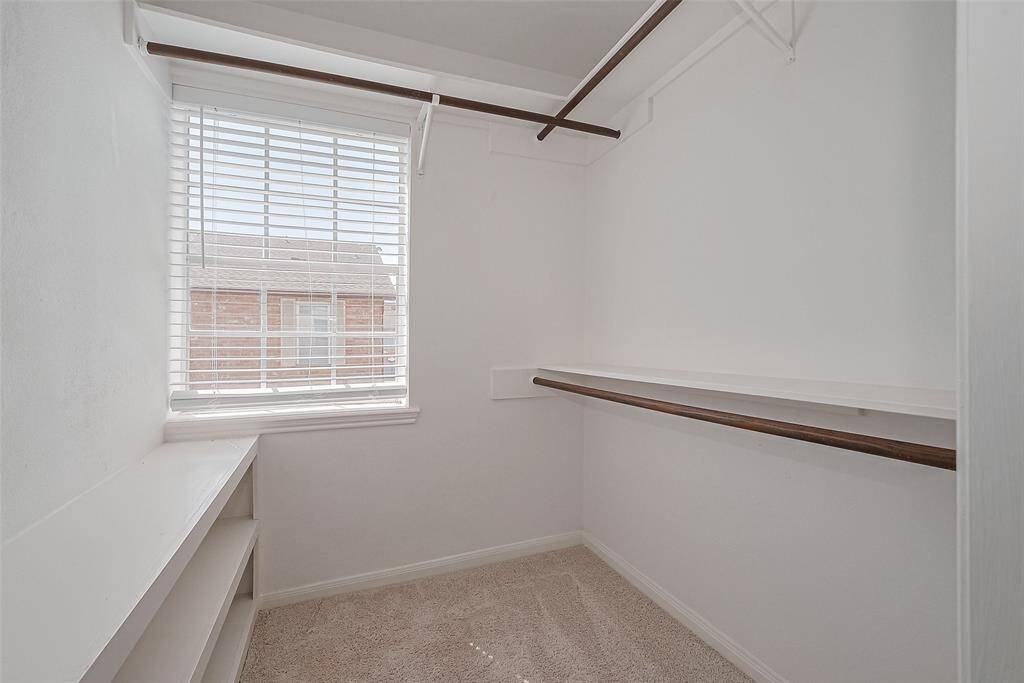 View of primary walk-in closet