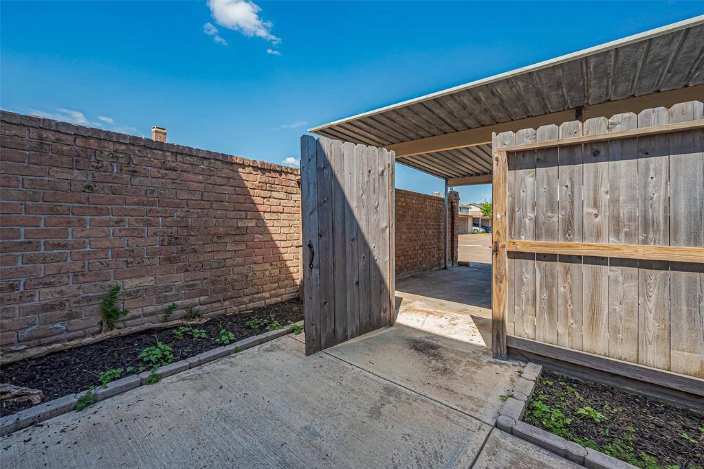Back gate leads to carport