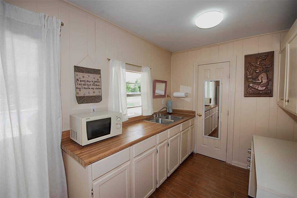 A closer look of the kitchenette area with double sink and fabulous storage.