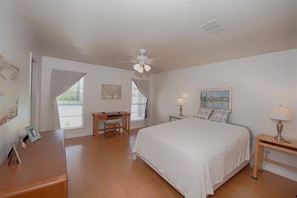 Primary bedroom at the back of the home with lovely views of the pool.