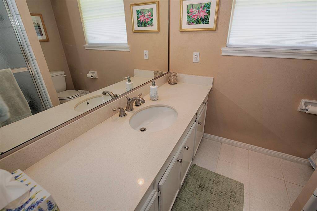 A closer look at the updated quartz vanity, offers ample counter space for all your necessities and or decor.