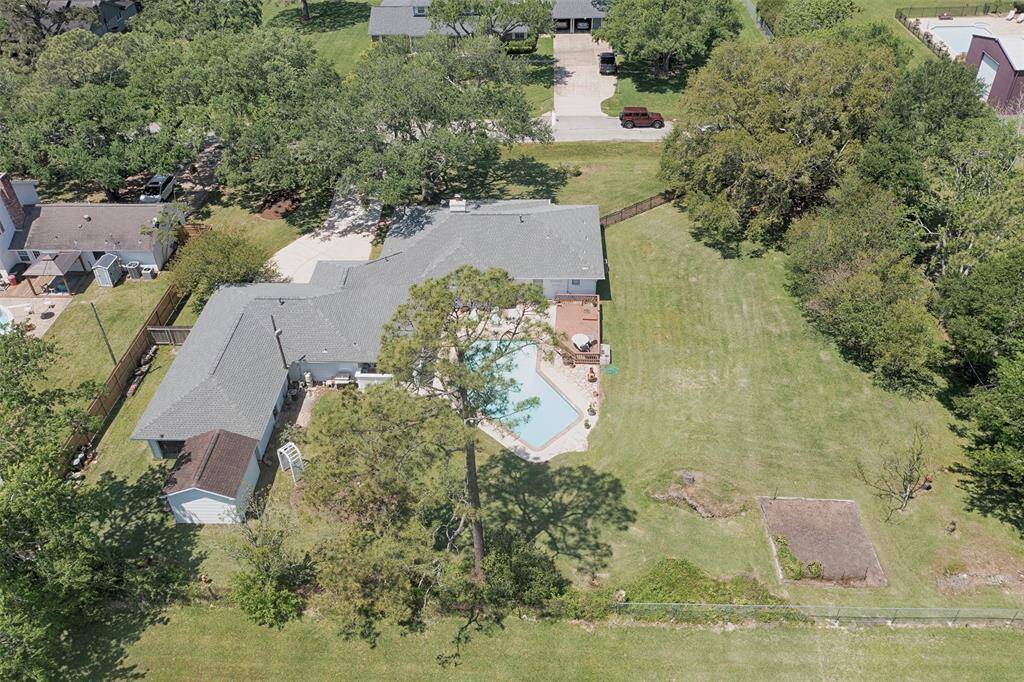 An aerial view of the backyard and pool showing the tremendous space in the backyard for outdoor fun this summer.  Be sure not to miss seeing the custom built 12 x 13 storage shed which is located behind the garage.