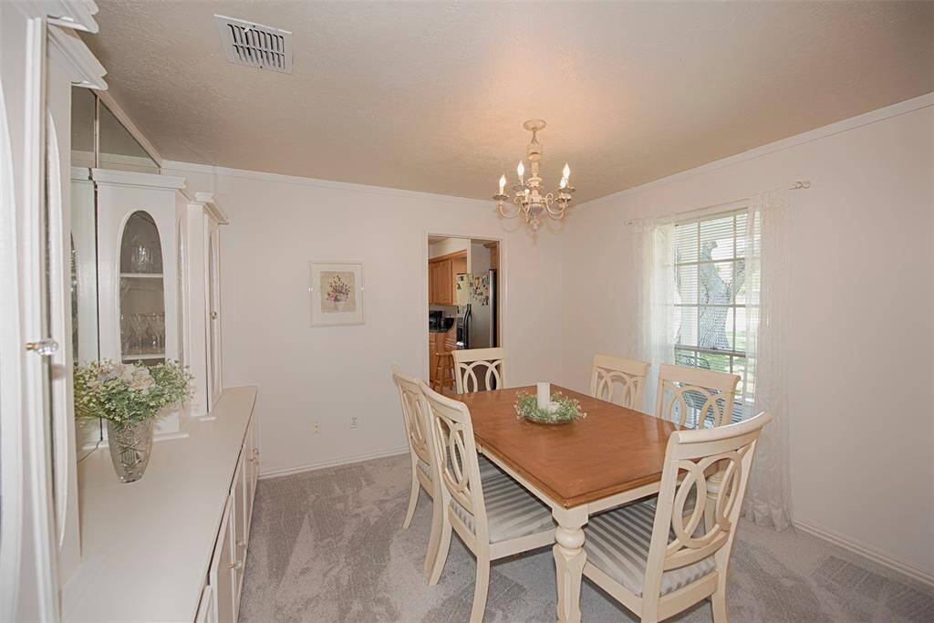 Formal dining room with a wall of built ins and easy access to the kitchen.