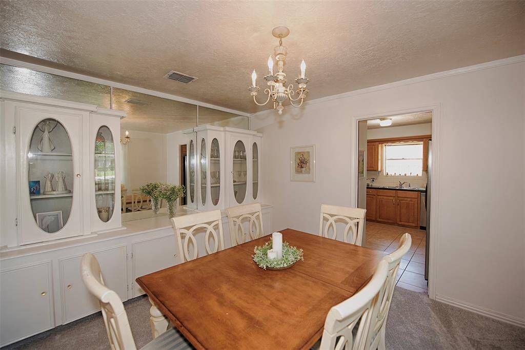 Another view of the formal dining room showing a wall of beautiful built in cabinetry and buffet.