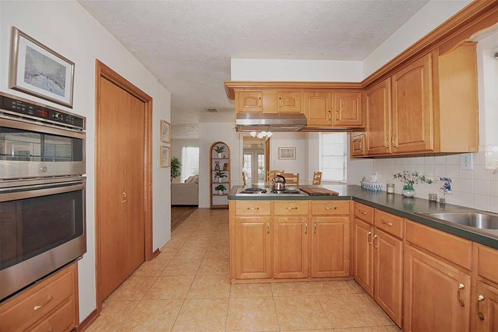 Entry to the kitchen from the formal dining area. Great storage and pantry.  The wall mounted oven and microwave, as well as the dishwasher were all recently replaced.