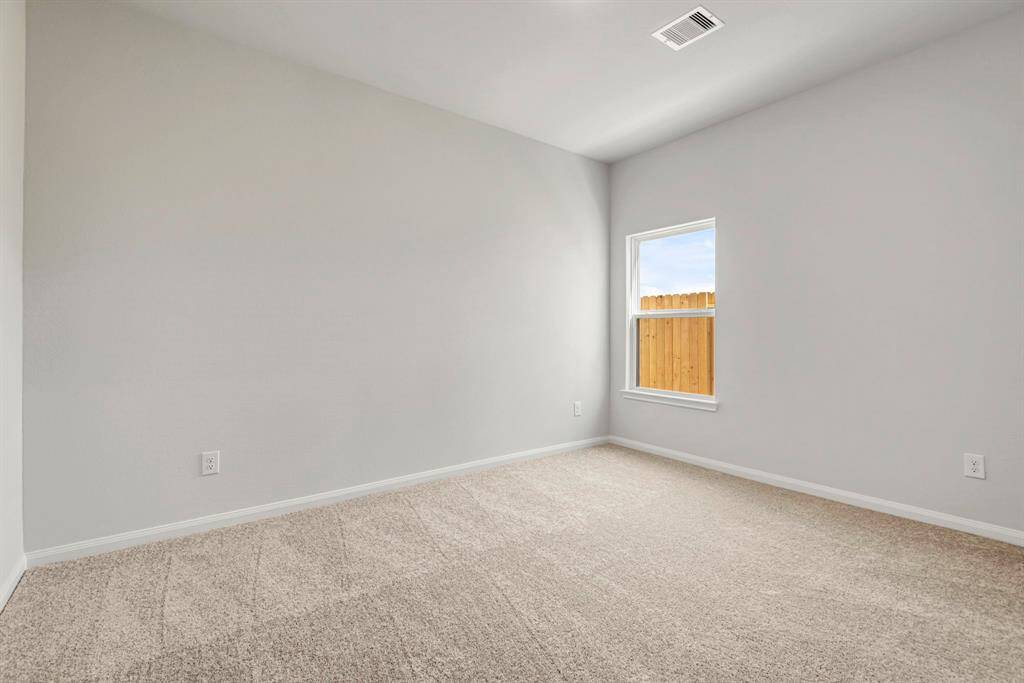 This is a spacious bedroom perfect for your family or home office.