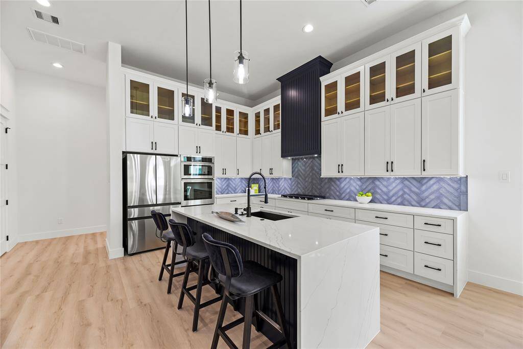 Another angle of the quartz island kitchen, refrigerator is included.