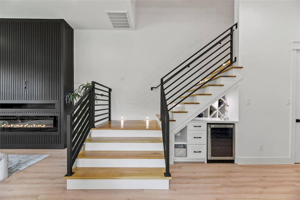 The stairs are upgraded solid oak wood with white painted risers and modern horizontal wrought iron, another aspect that will be much appreciated is how wide this staircase is, the first floor landing is approximately 5 feet wide, and stairwell is 4' wide.