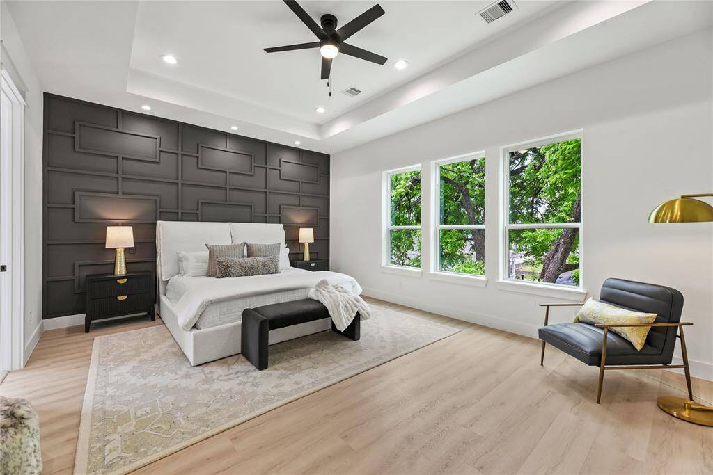 The Primary is very spacious / oversized sitting at 21 feet by 15 feet, space will NOT be an issue. Room includes a decorative mature accented bedwall with smart lighting for both sides of the bed, if you look above the bed the 3 recessed lights can be operated by two-way switches from either side of the bed, very thoughtful and very nice to have this feature.
