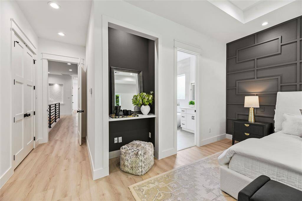 Primary bedroom includes a vanity area with built-in quartz tabletop.