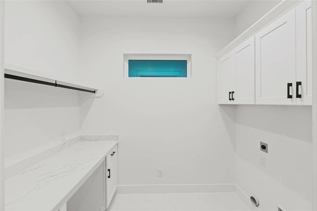 In-home fabulous laundry room, spacious with folding table, raised cabinetry in case you have a top load washing machine.