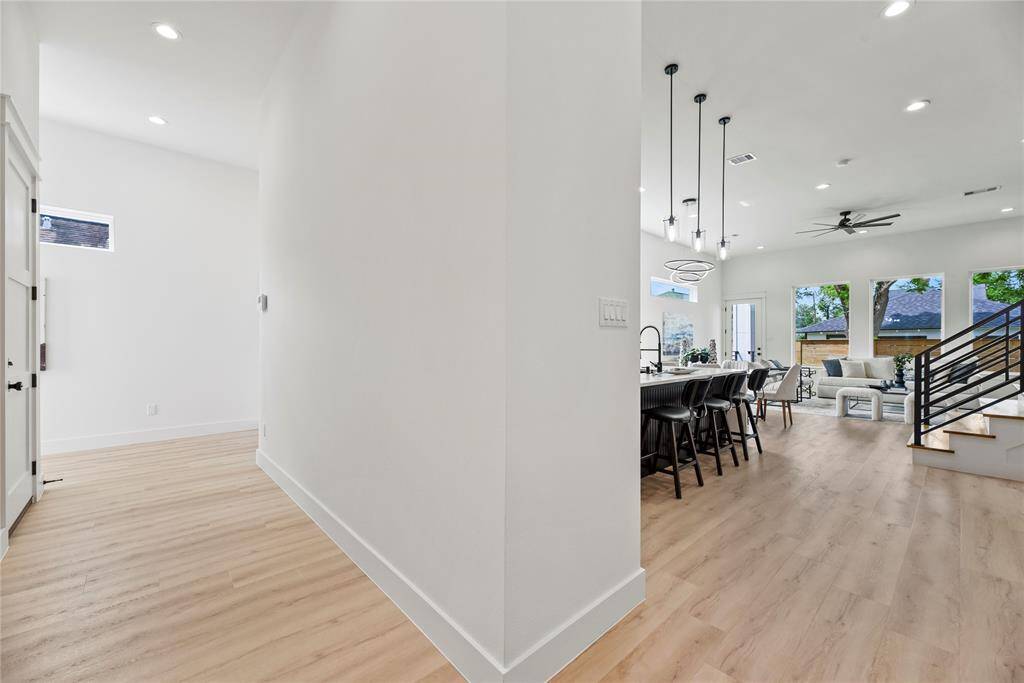 The entry foyer also features a conveniently located powder bath for guests while also providing egress to the oversized garage all thoughtfully positioned to maintain privacy from the home's main living areas.