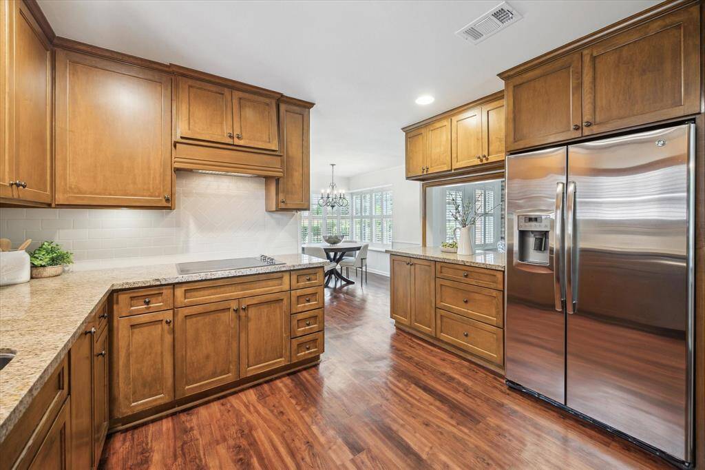 Kitchen updated approximately 10-15 years ago features stainless steel appliances, granite counters and solid cabinetry.