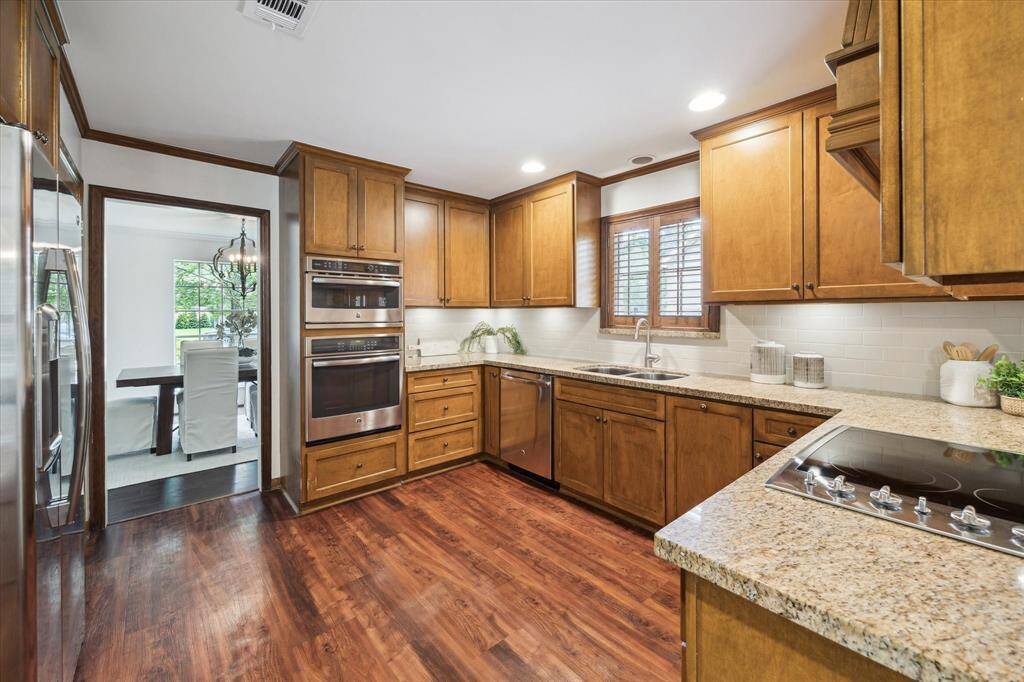 Kitchen updated approximately 10-15 years ago features stainless steel appliances, granite counters and solid cabinetry.