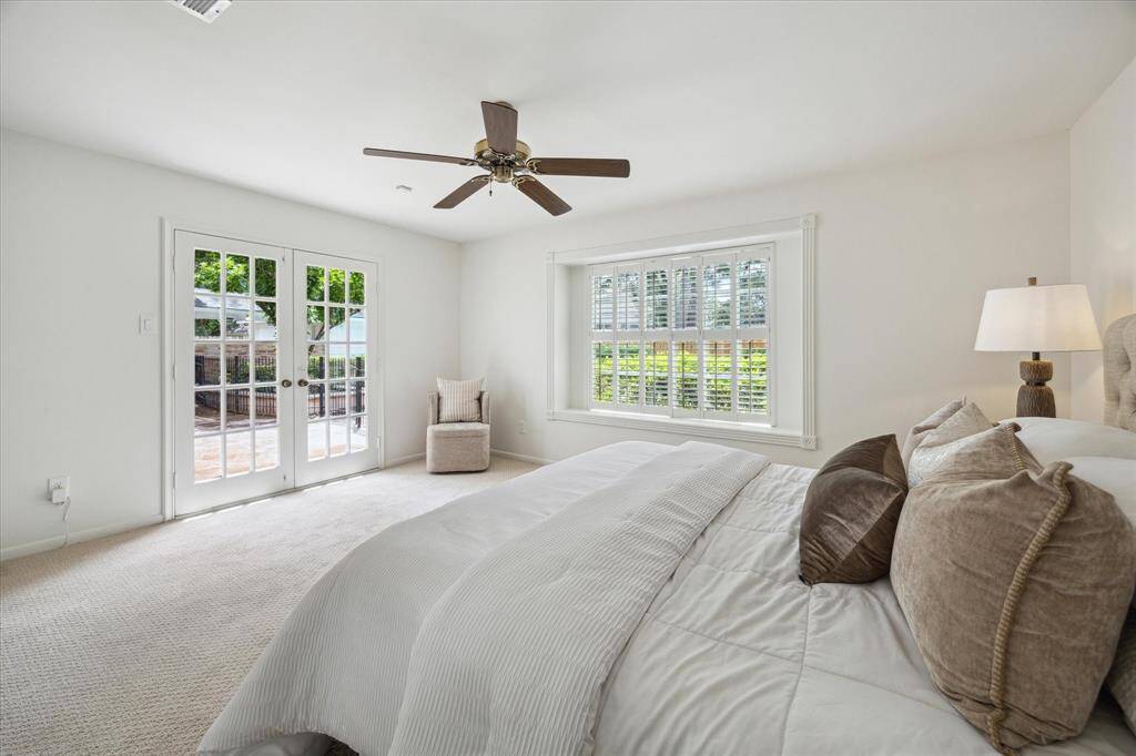 Downstairs Primary suite with French door access to the back patio and views of the serene back yard.